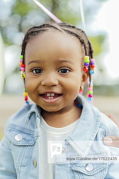 Cute little girl with braided hair at park