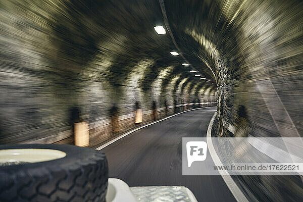 Off-road vehicle under illuminated tunnel  Stelvio Pass  South Tyrol  Italy