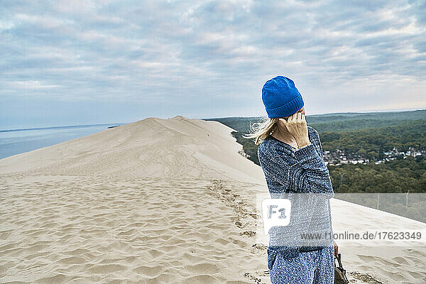 Tourist exploring sand dune on vacation