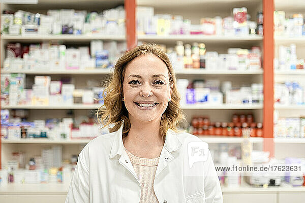 Happy female pharmacist at pharmacy store