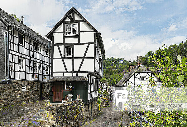 Germany  North Rhine-Westphalia  Monschau  Half-timbered townhouses along street in medieval town