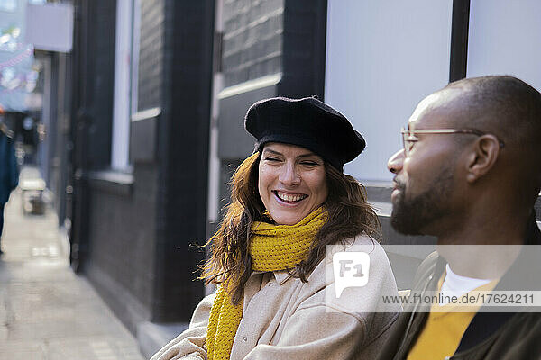 Man looking at happy woman with beret