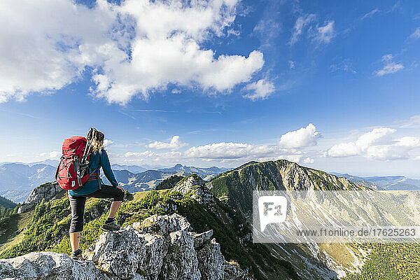 Female hiker admiring view from summit of Aiplspitz mountain