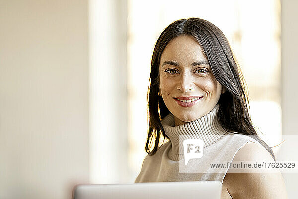 Happy beautiful businesswoman at home