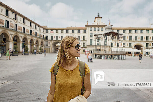 Woman wearing sunglasses standing at town