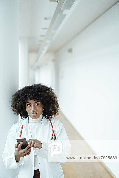 Healthcare worker with smart phone in hospital