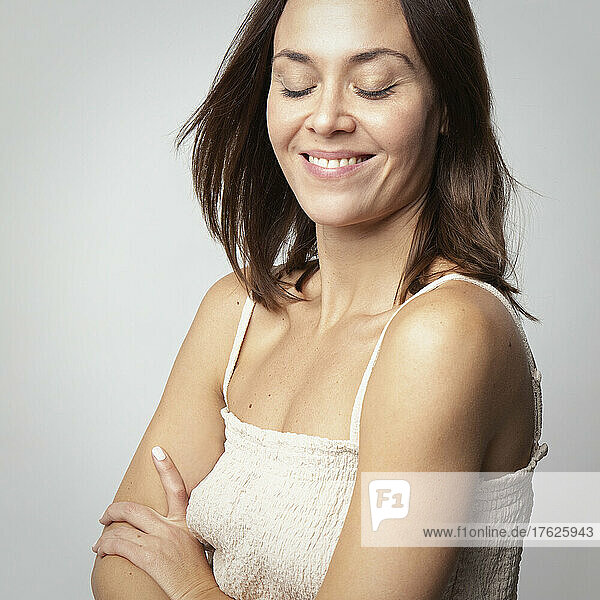 Smiling beautiful woman with brown hair in studio