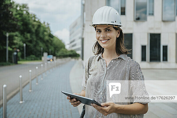 Architect holding tablet PC at construction site