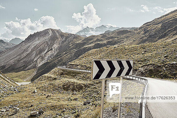 Sign board by road and mountains  Italy