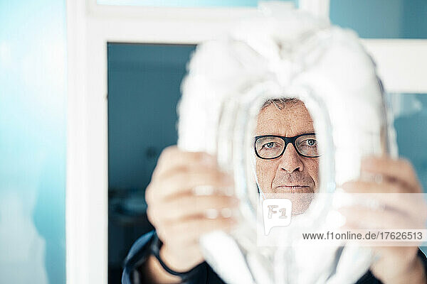 Businessman with eyeglasses looking through object