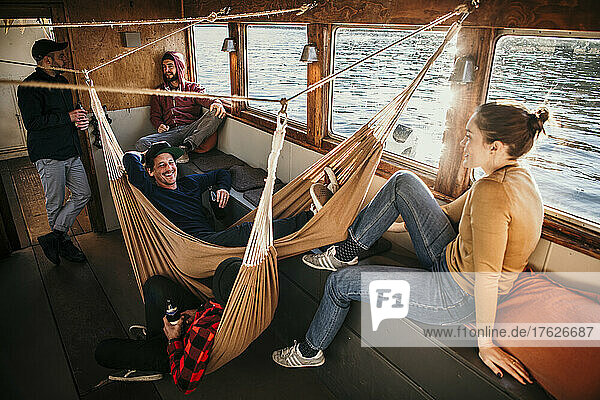 Happy friends enjoying leisure time together on boat
