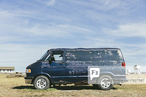 An old abandoned van in a field in Montana.