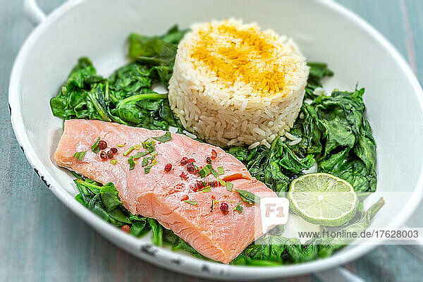 Salmon fillet with rice and spinach garnish.