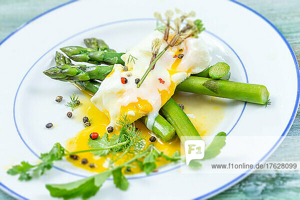 Fish fillet with asparagus curry sauce on blue wooden background.
