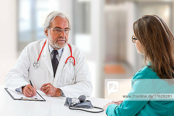 Consultation of a young woman with a doctor.