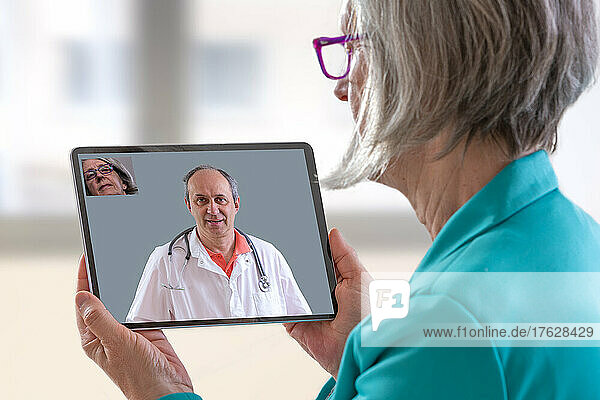 Patient with tablet  having remote consultation with doctor.