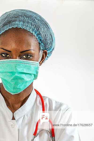 Female american african doctor  nurse woman wearing medical coat with stethoscope and mask. Happy excited for success medical worker