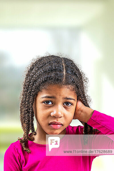 Little African-American girl with hearing problem maybe suspicion of otitis