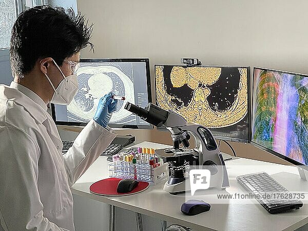 Laboratory technician doing research with images of the coronavirus on a computer.