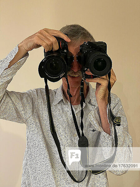 Photographer with a device for each eye  concept.