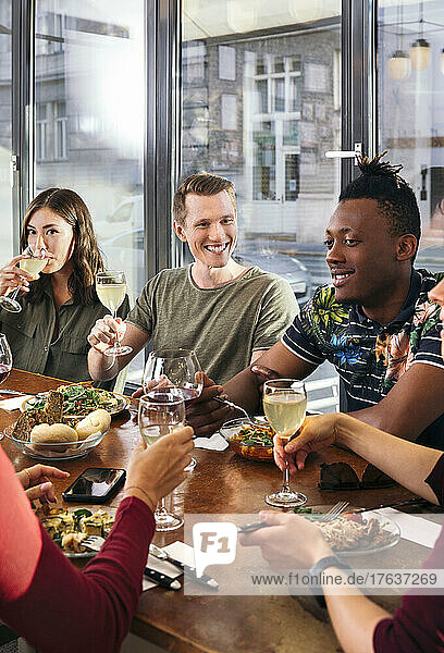 Group of friends enjoying meal in restaurant