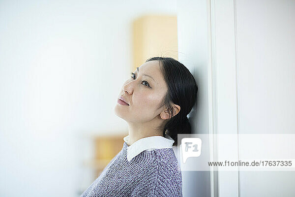 Pensive woman at home