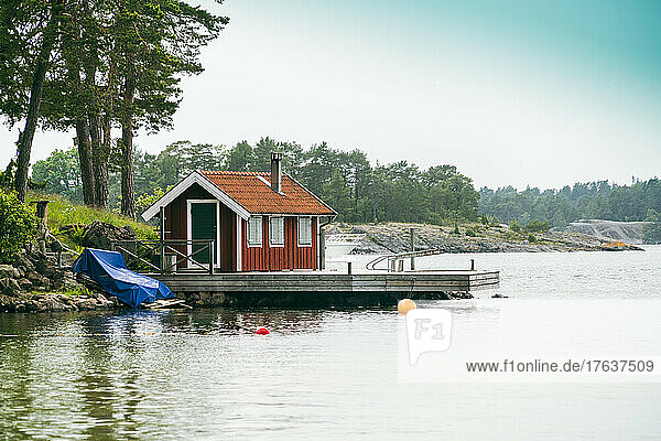 Sweden  Gransoleden island  Small house and pier on coast