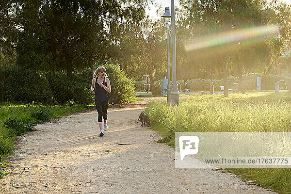 Mature woman jogging with dog