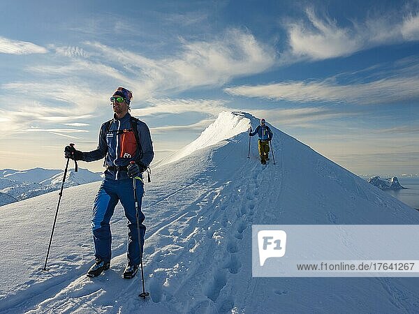 Two climbers on the summit ridge of Husafjellet  Senja Island  Troms  Norway  Europe