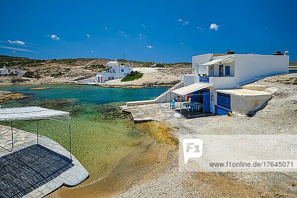 Greece scenic island view  small harbor with crystal clear turquoise water  traditishional whitewashed house. Pachena village  Milos island  Greece