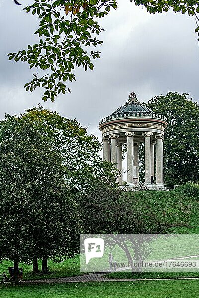 Man and child walking in the English Garden of Munich in front of the Monopteros  Germany  Europe