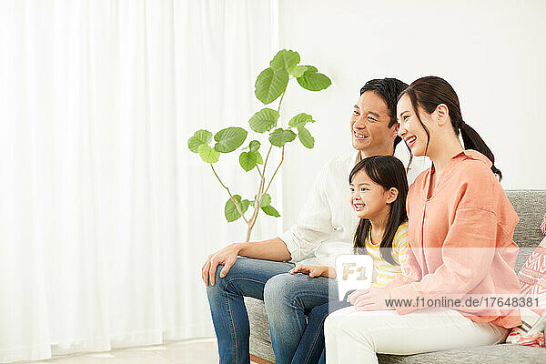 Japanese family relaxing on the sofa
