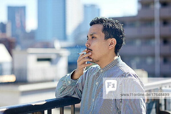 Japanese man smoking outside