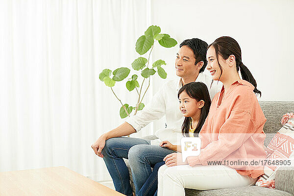 Japanese family relaxing on the sofa