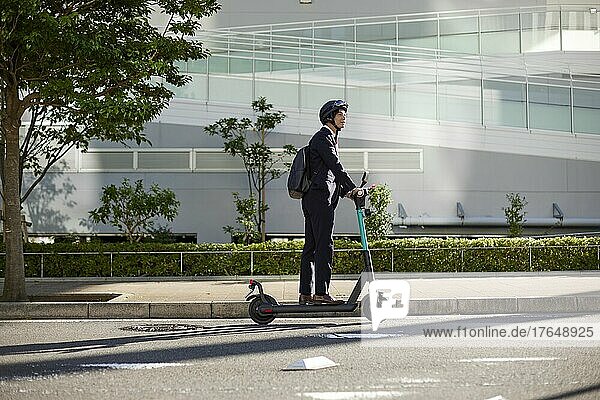 Japanese man with electric scooter