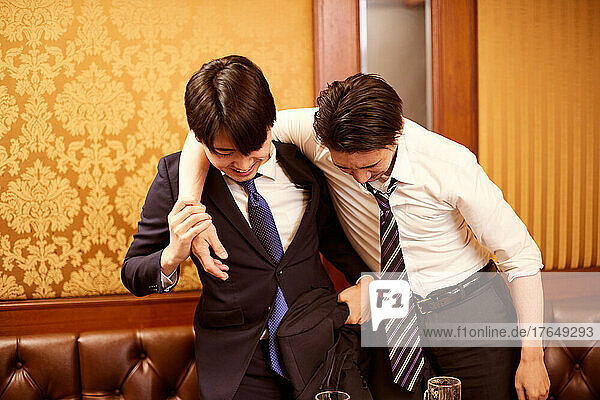 Japanese businesspeople having drinks at karaoke