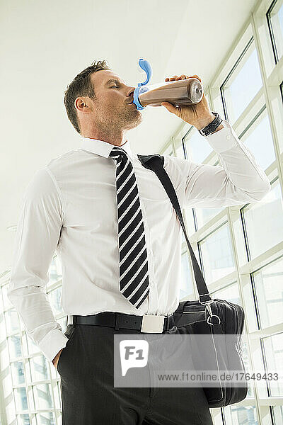 Businessman drinking protein shake in office
