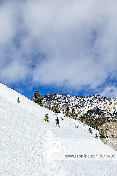 United States  Idaho  Ketchum  Senior woman snowshoeing near Sun Valley on sunny winter day