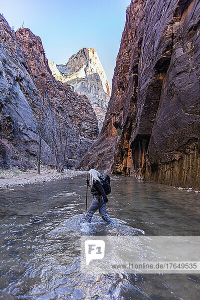 United States  Utah  Zion National Park  Senior female hiker wading The Narrows of Virgin River in Zion National Park