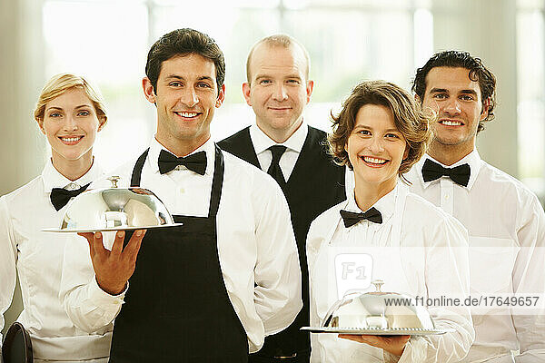 Group of waiters carrying trays