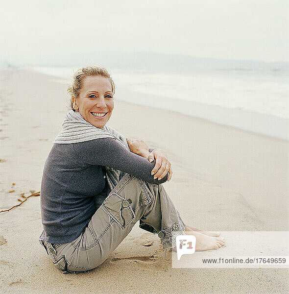Portrait of woman relaxing on beach