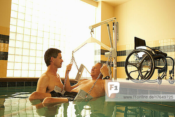 Physical therapist and patient in hospital pool