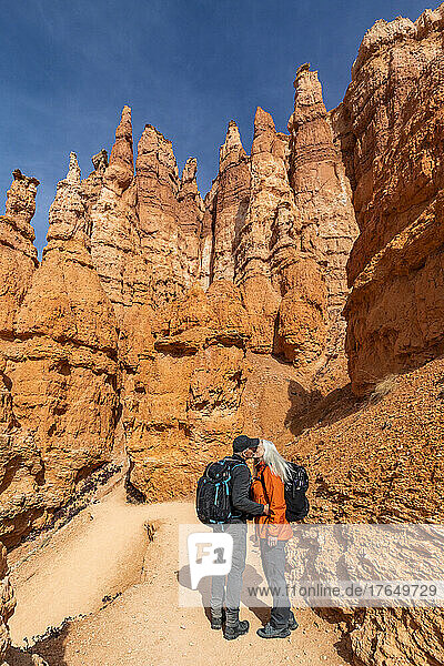 United States  Utah  Bryce Canyon National Park  Senior hiker couple kissing while exploring Bryce Canyon National Park