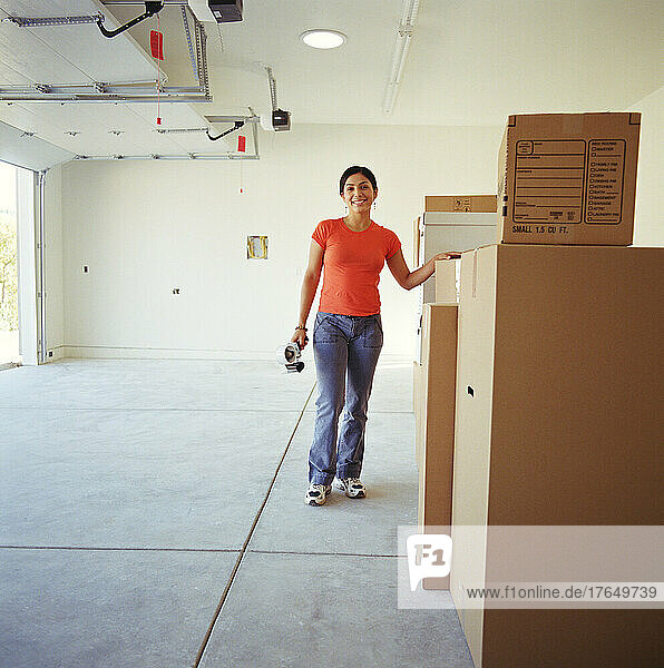Woman in garage with moving boxes
