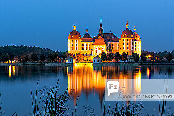 Germany  Saxony  Moritzburg  Long exposure of lake and illuminated Moritzburg Castle at dusk