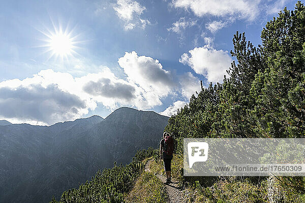 Sun shining over female hiker in Karwendel range