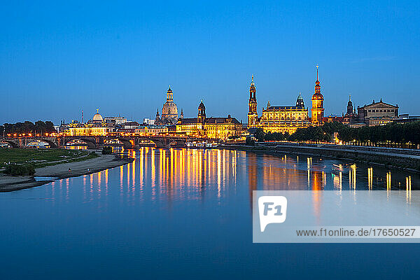 Germany  Saxony  Dresden  Long exposure of Elbe river at dusk with illuminated old town buildings in background