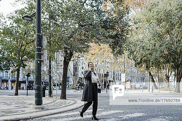 Woman crossing street in city