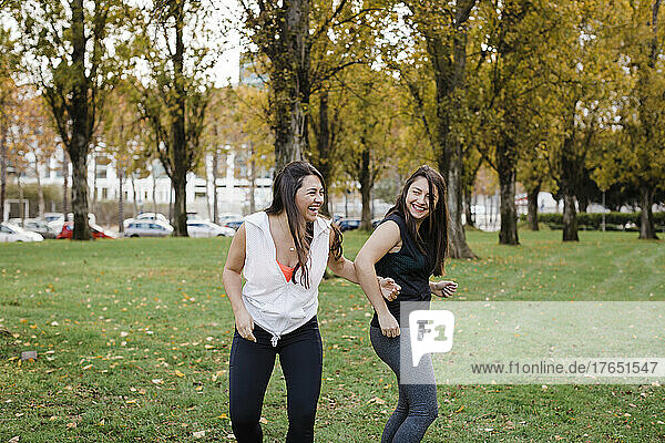 Happy sisters having fun in public park