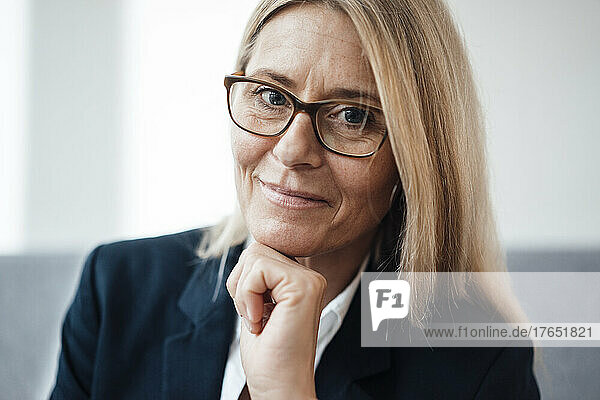 Businesswoman with hand on chin in office